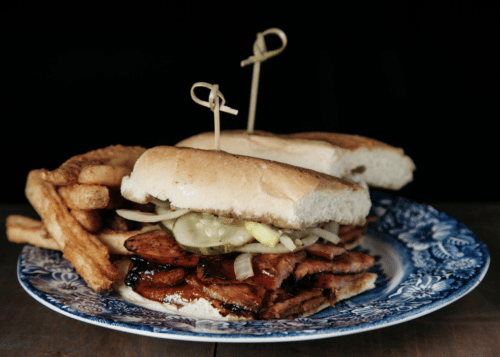 Sausage poboy sandwich with french fries